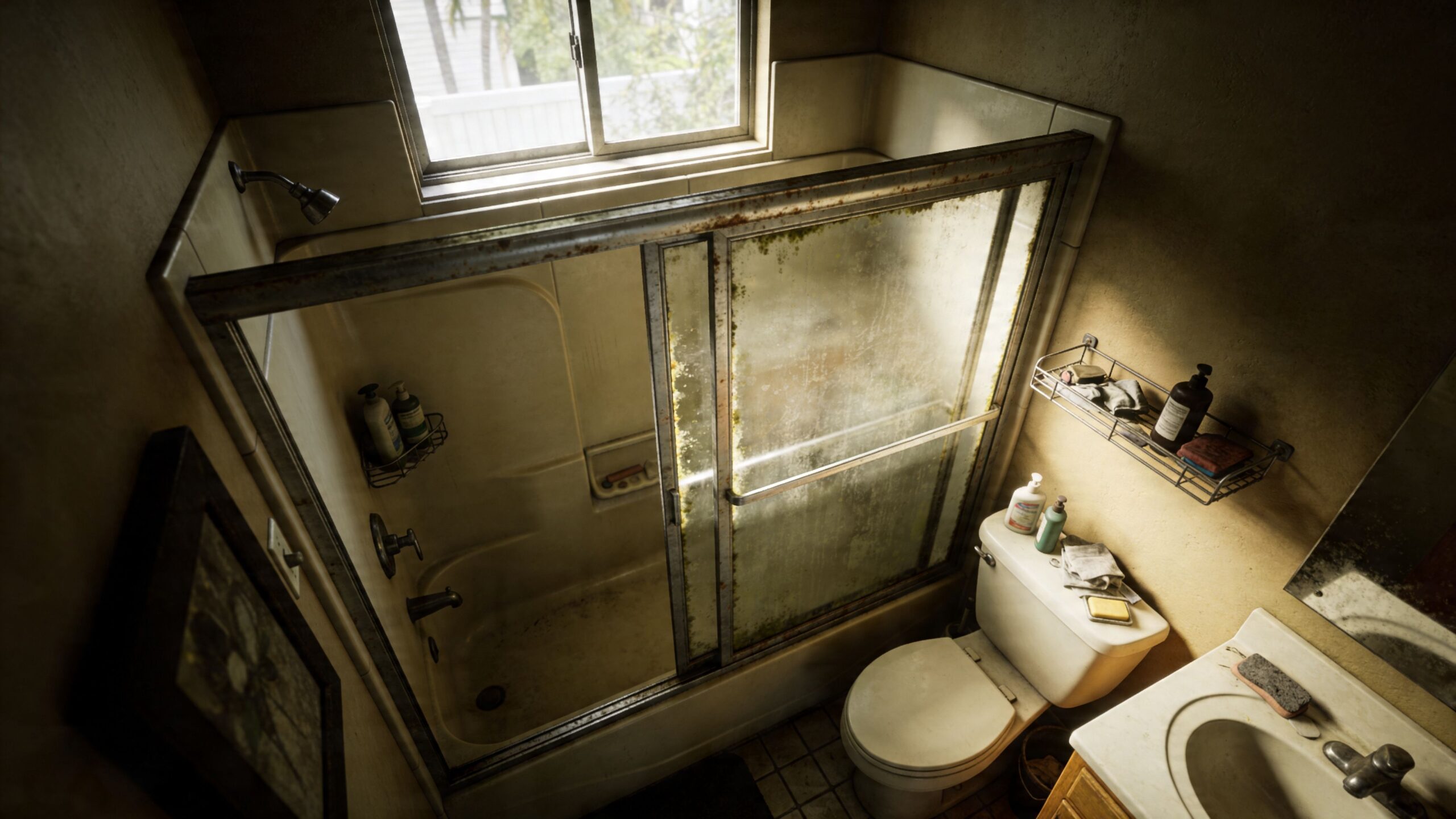 A high-angle view of a rustic, aged bathroom featuring a dirty sliding glass shower door enclosure.