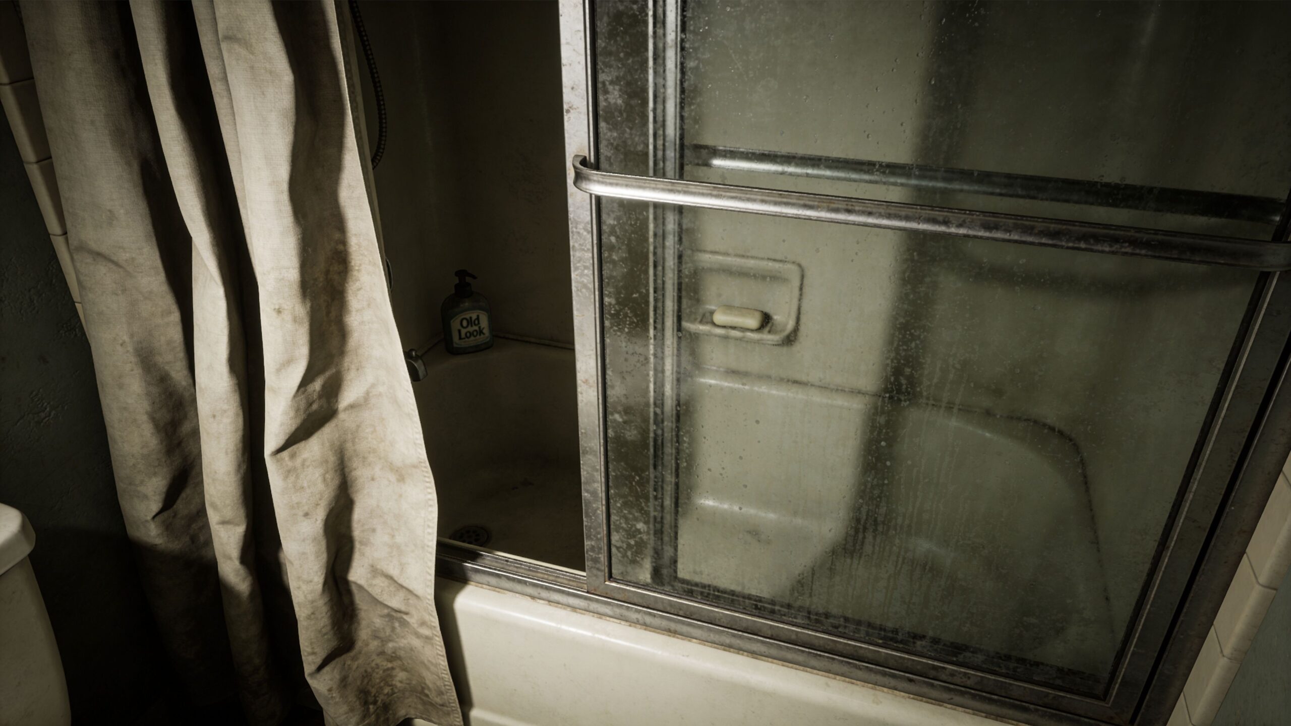 A dirty bathroom shower featuring sliding glass doors and an old bar of soap in the tray.