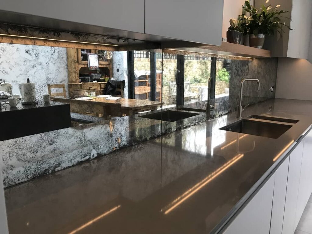 Antique mirror backsplashes offer a unique alternative to traditional wall finishes in kitchens, bars, and feature areas